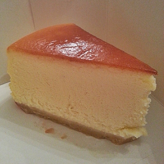 a close up of a piece of cheesecake on a paper