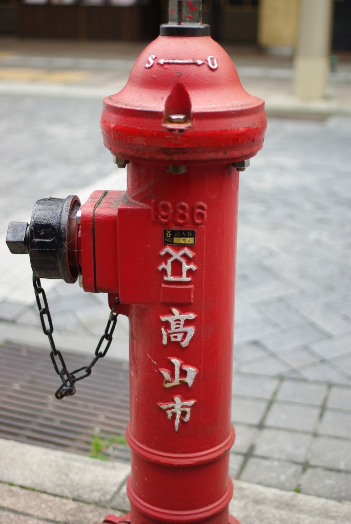 a red fire hydrant that is standing on a sidewalk