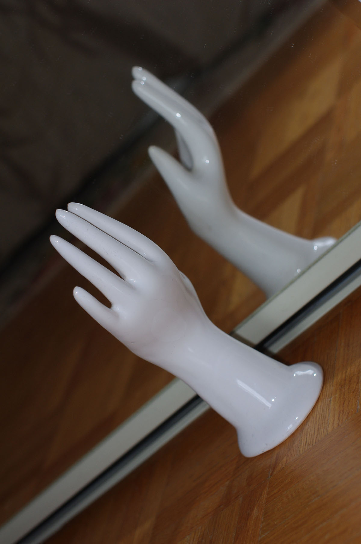 white plastic hands are next to a mirror