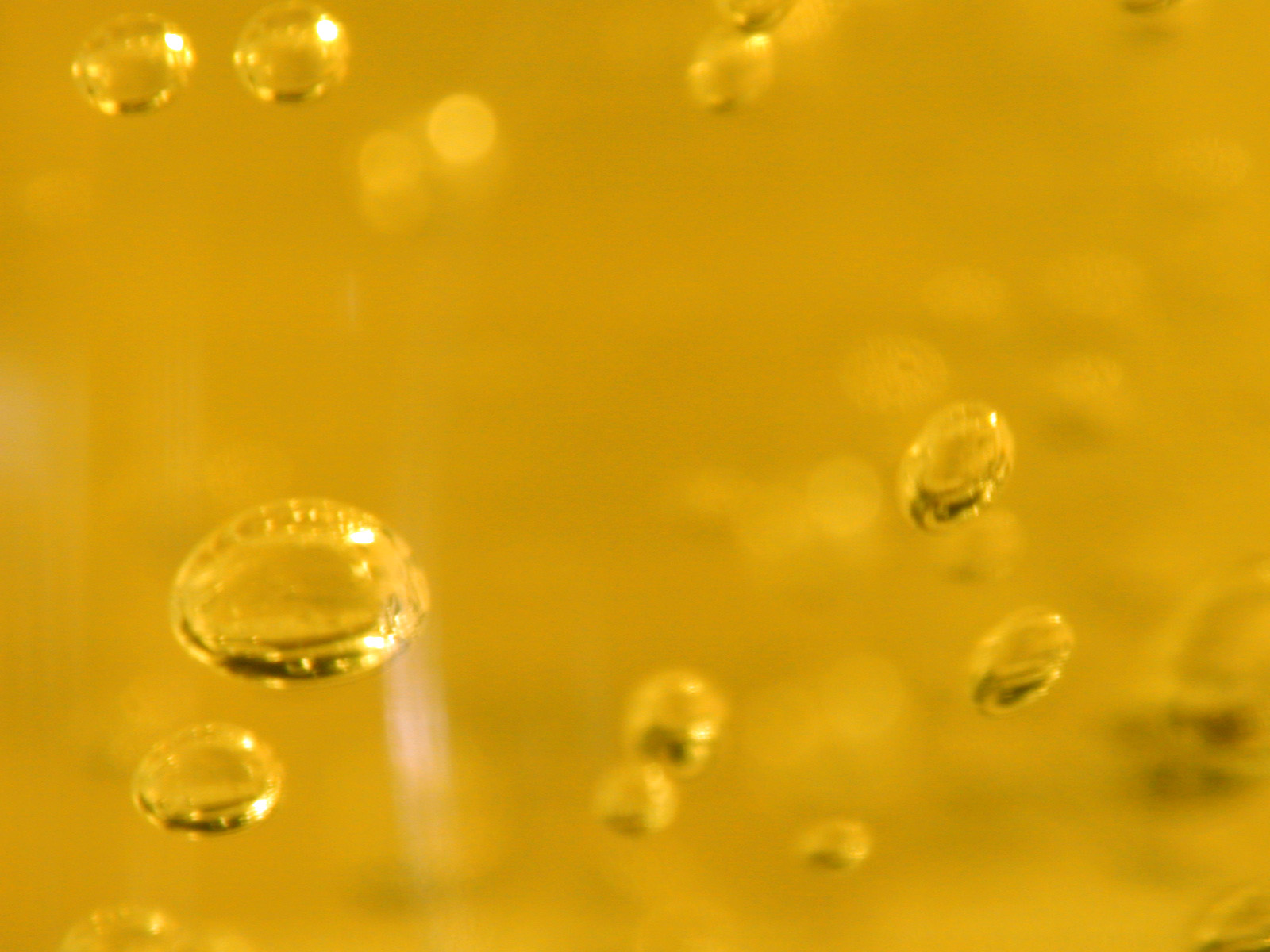 drops of water are on a yellow surface