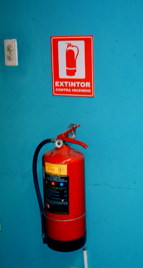 a person holding their hands next to a fire extinguisher