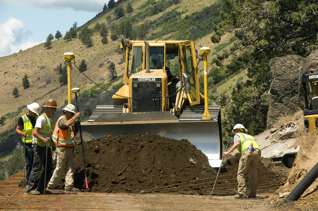 workers are standing outside working on a construction site