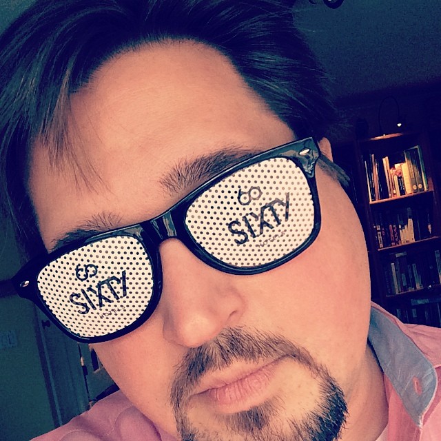 a man with glasses that say sky on them