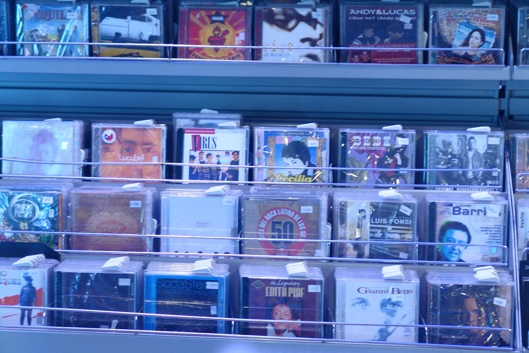 a collection of books sitting on top of a book shelf