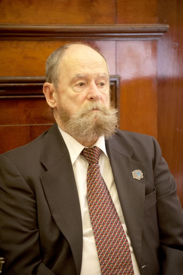 a man with a white beard and suit
