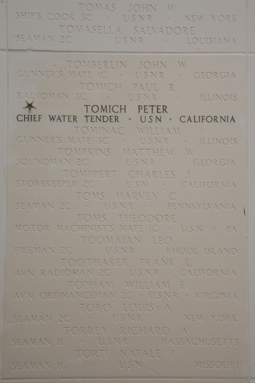 a plaque on the wall with names in english and spanish