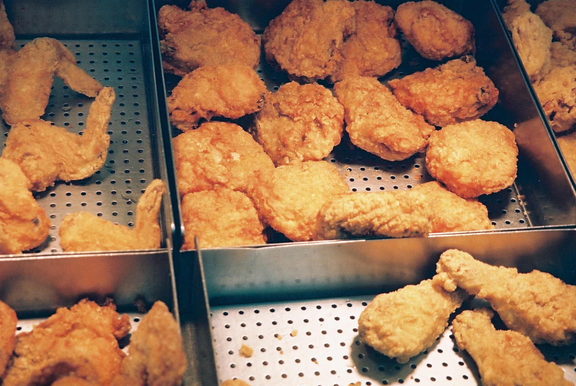 several tins of chicken are seen in a display case