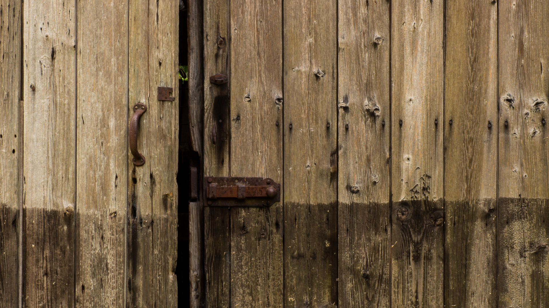 an old brown wooden door is open