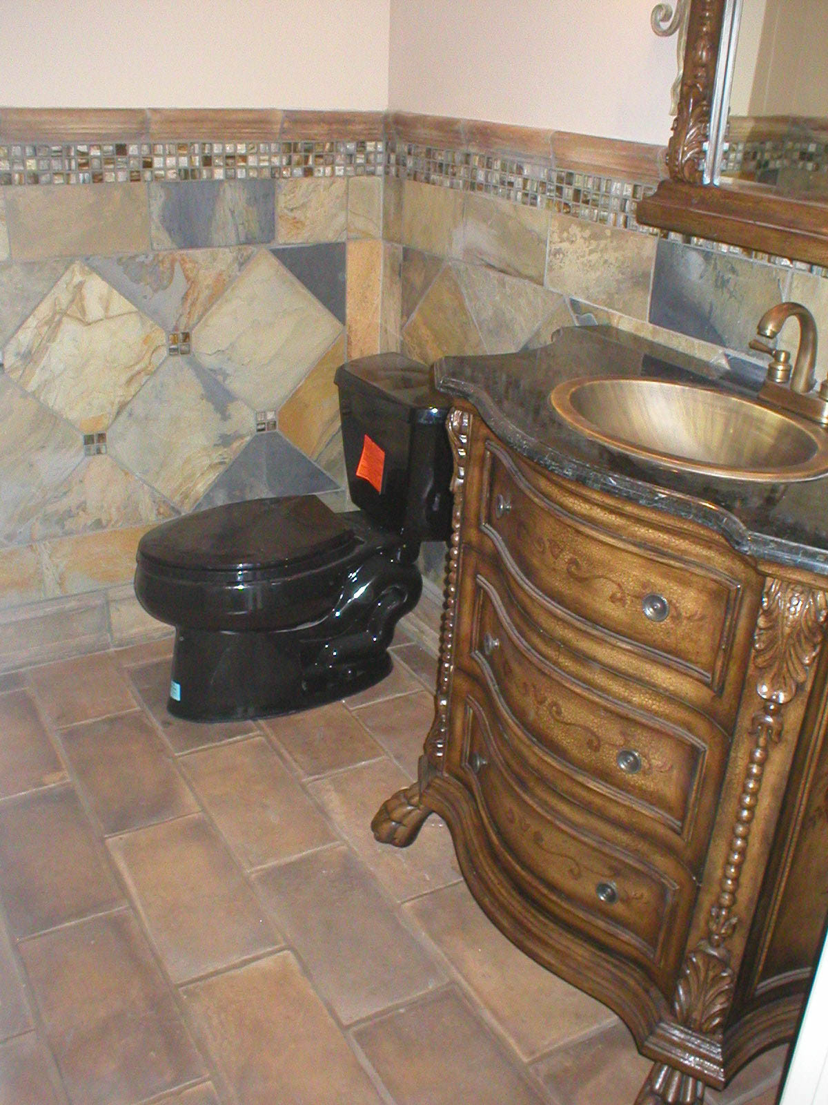 an ornate bathroom with stone wall and vanity