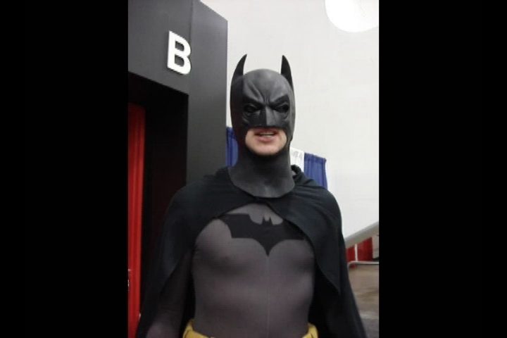 the man is dressed up as batman for halloween