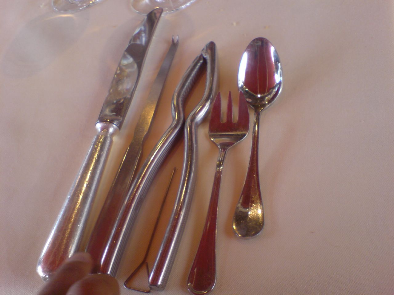 a table topped with metal forks and silverware
