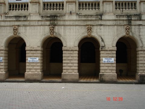 several arched doorways with white signage on them