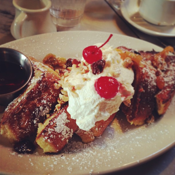 dessert on the plate on the table near silver cups