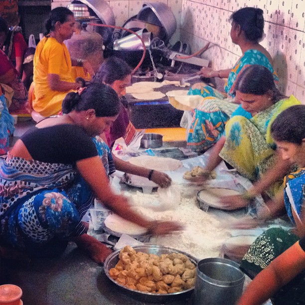several women in a kitchen making baked goods