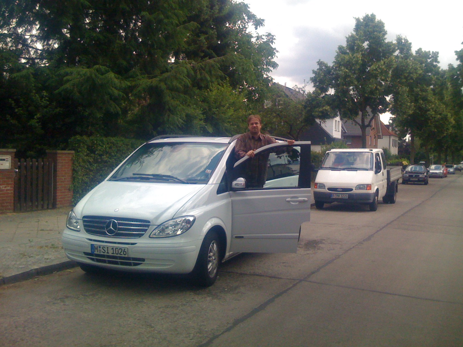 there is a man sitting in a white van