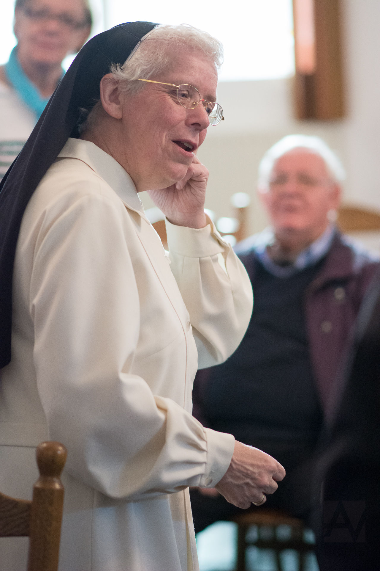 the woman in a religious outfit is holding her finger out