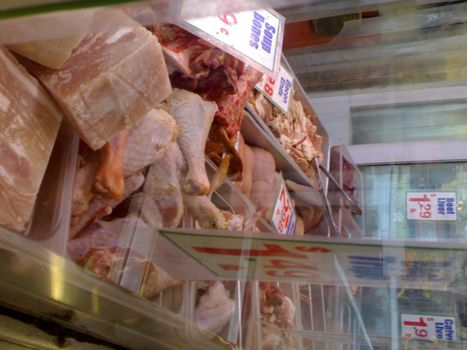 a grocery store filled with packaged meats and meat on display