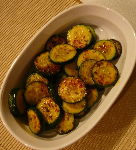 a bowl full of sliced up zucchini on a table