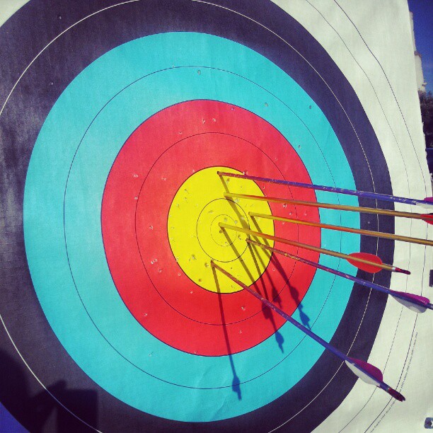some arrows are seen in a large archery target