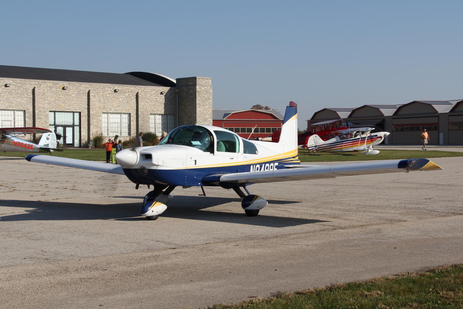 an airplane sits parked on the pavement at an airport