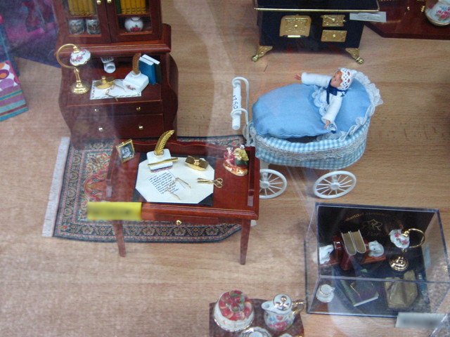 miniature figurines on display in a shop window
