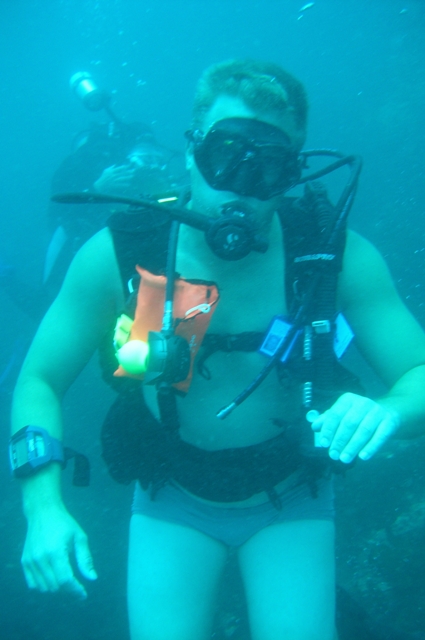 the person wearing a diving mask holds a life preserver