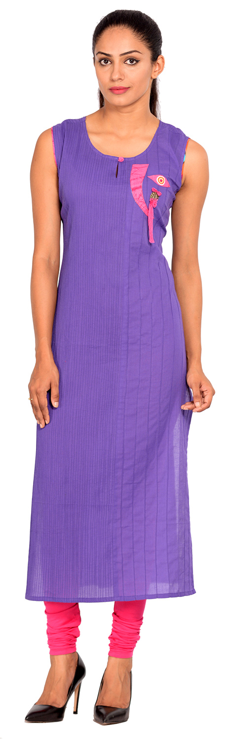 a woman in purple dress posing for the camera