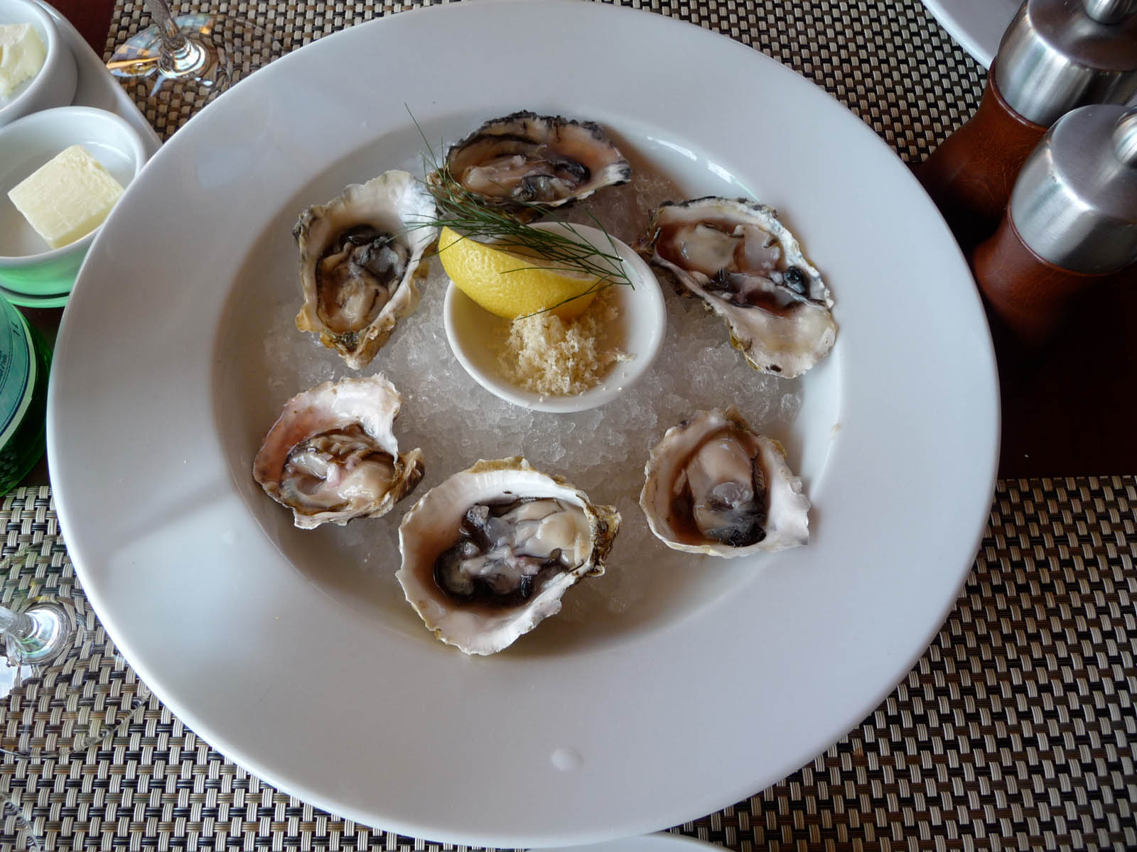 a plate topped with oysters and a lemon