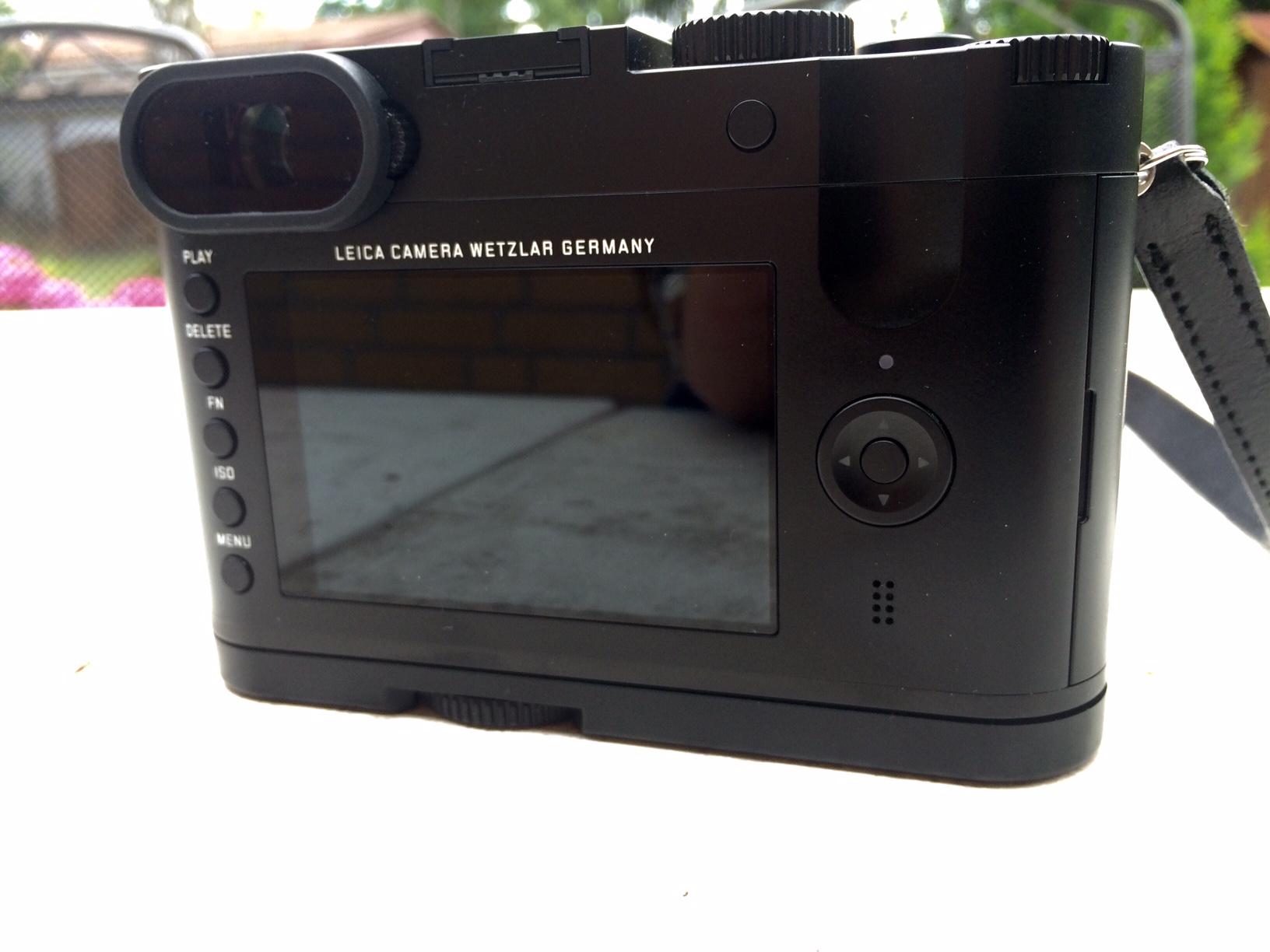 a small digital camera with its back facing the viewer