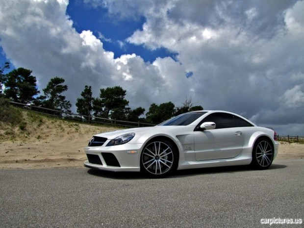 a white sports car parked on the side of a road