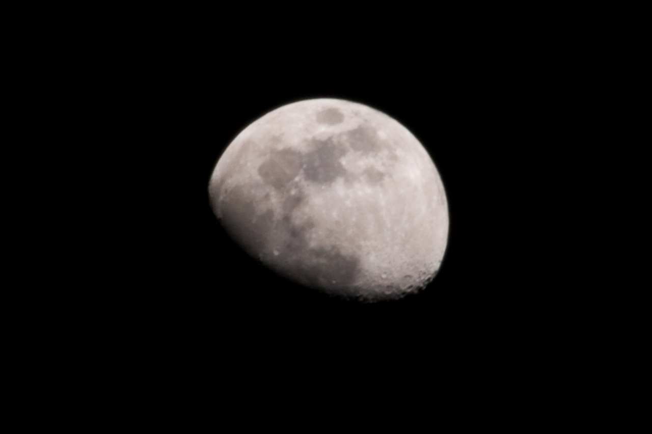 the half moon is seen against a dark sky