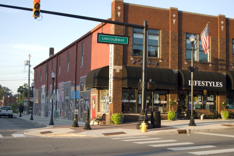an intersection showing a brick storefront and a traffic light