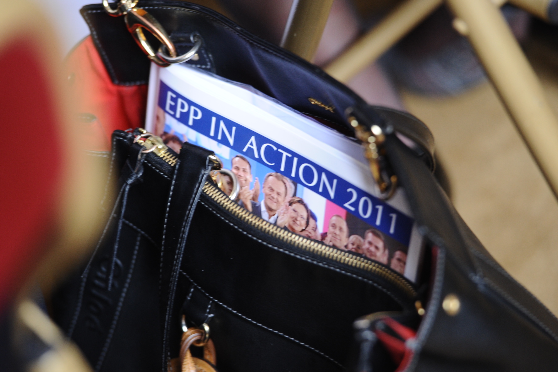 a magazine is in the pocket of a purse