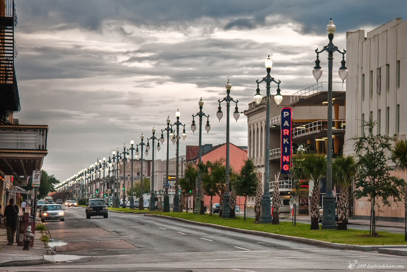 a street is empty with several lamps along it