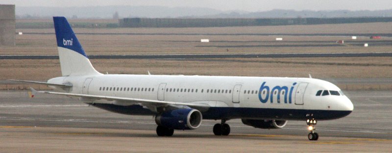 a plane with blue lettering is parked on the runway