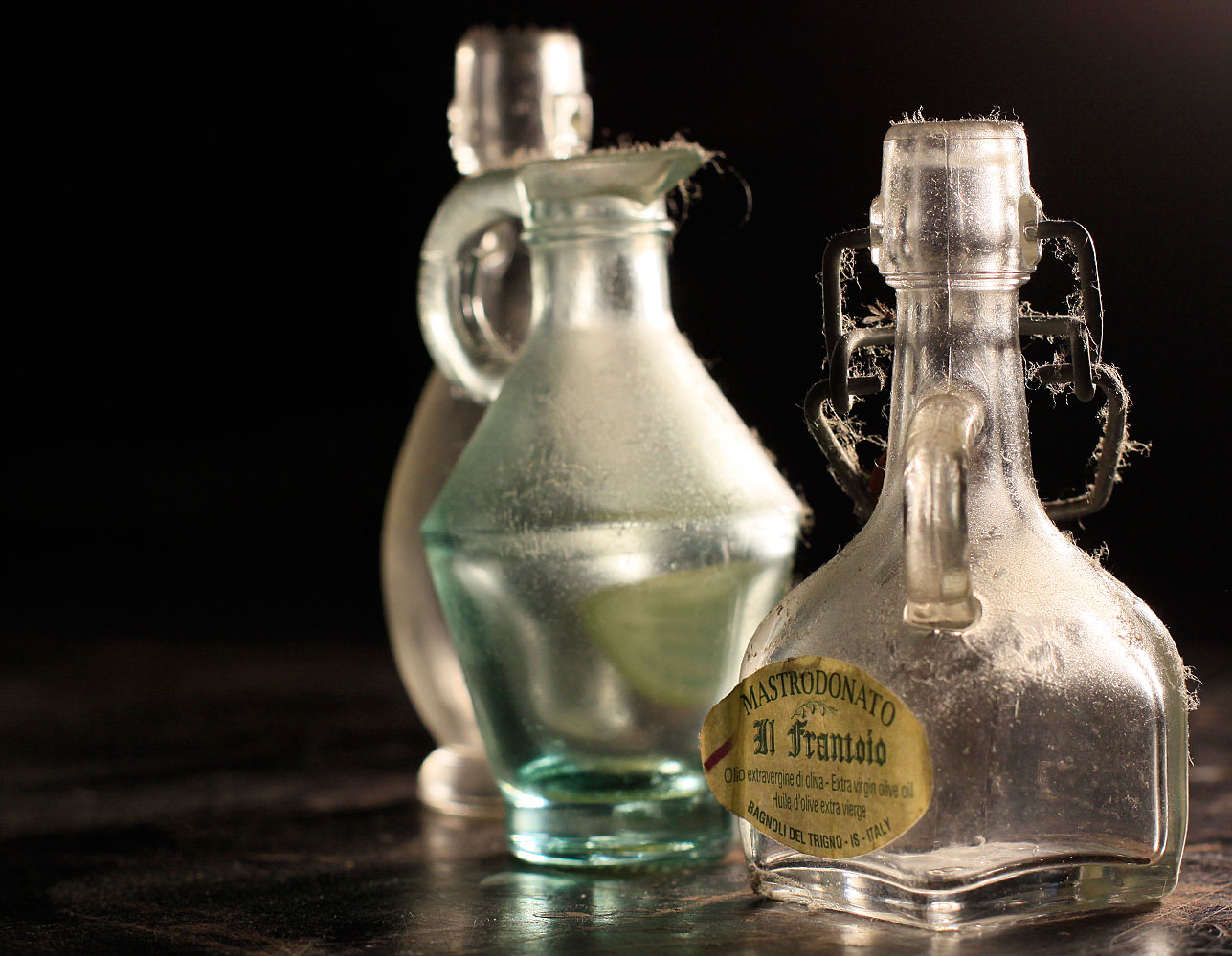 a few old glass liquor bottles that are on a counter