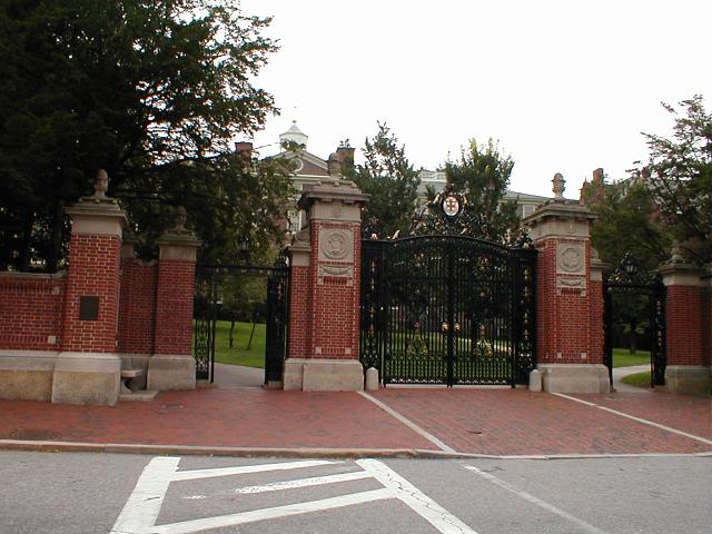 a street that has a red brick wall and gate