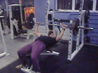 a man is lying down in the gym doing heavy exercises