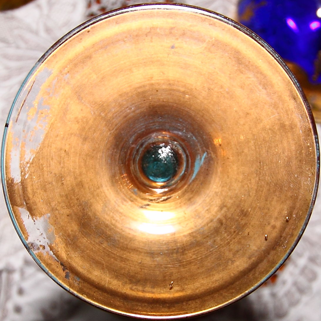 gold plate with blue glass bowl inside of it