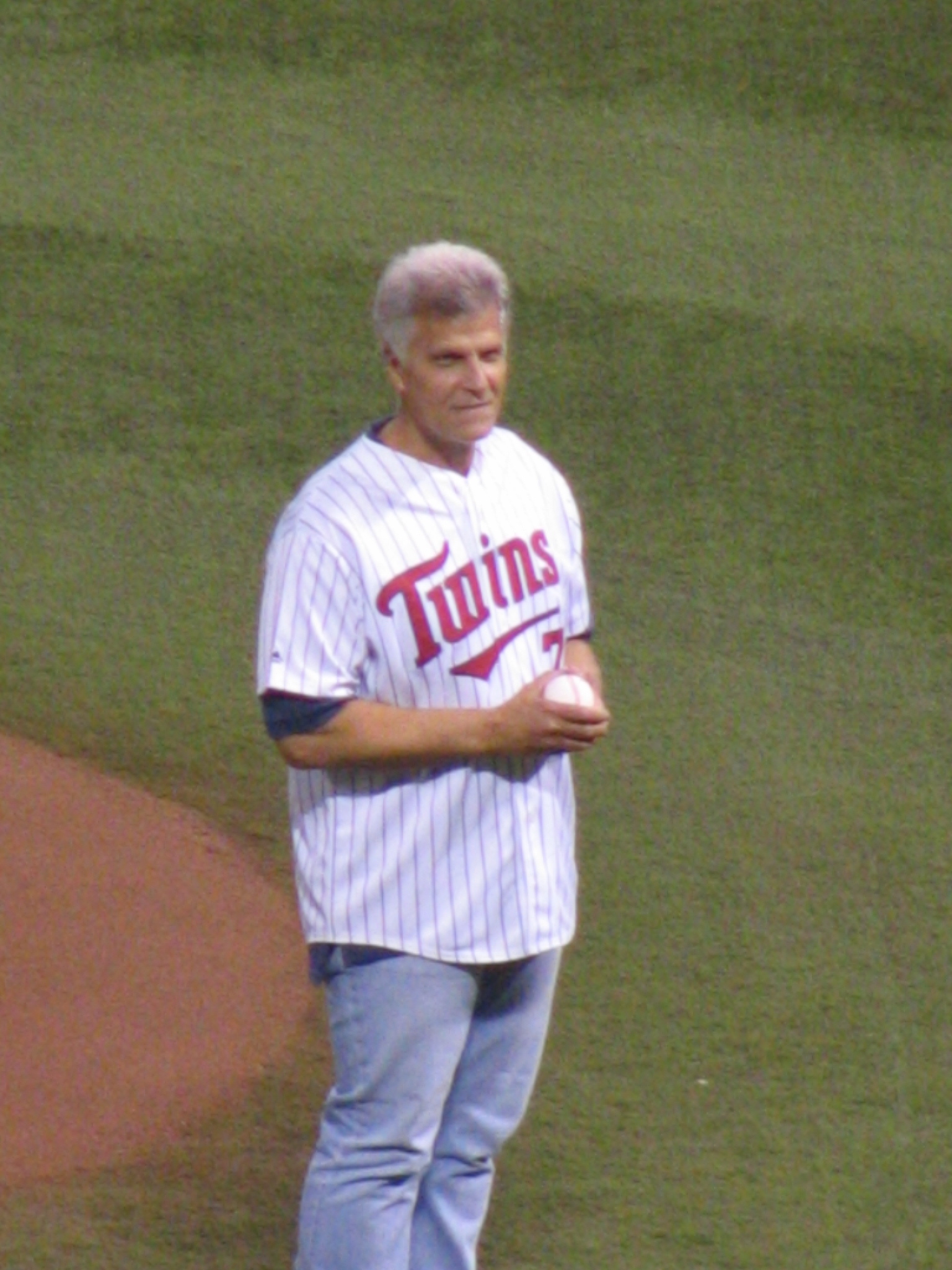 a man is holding a ball on the field