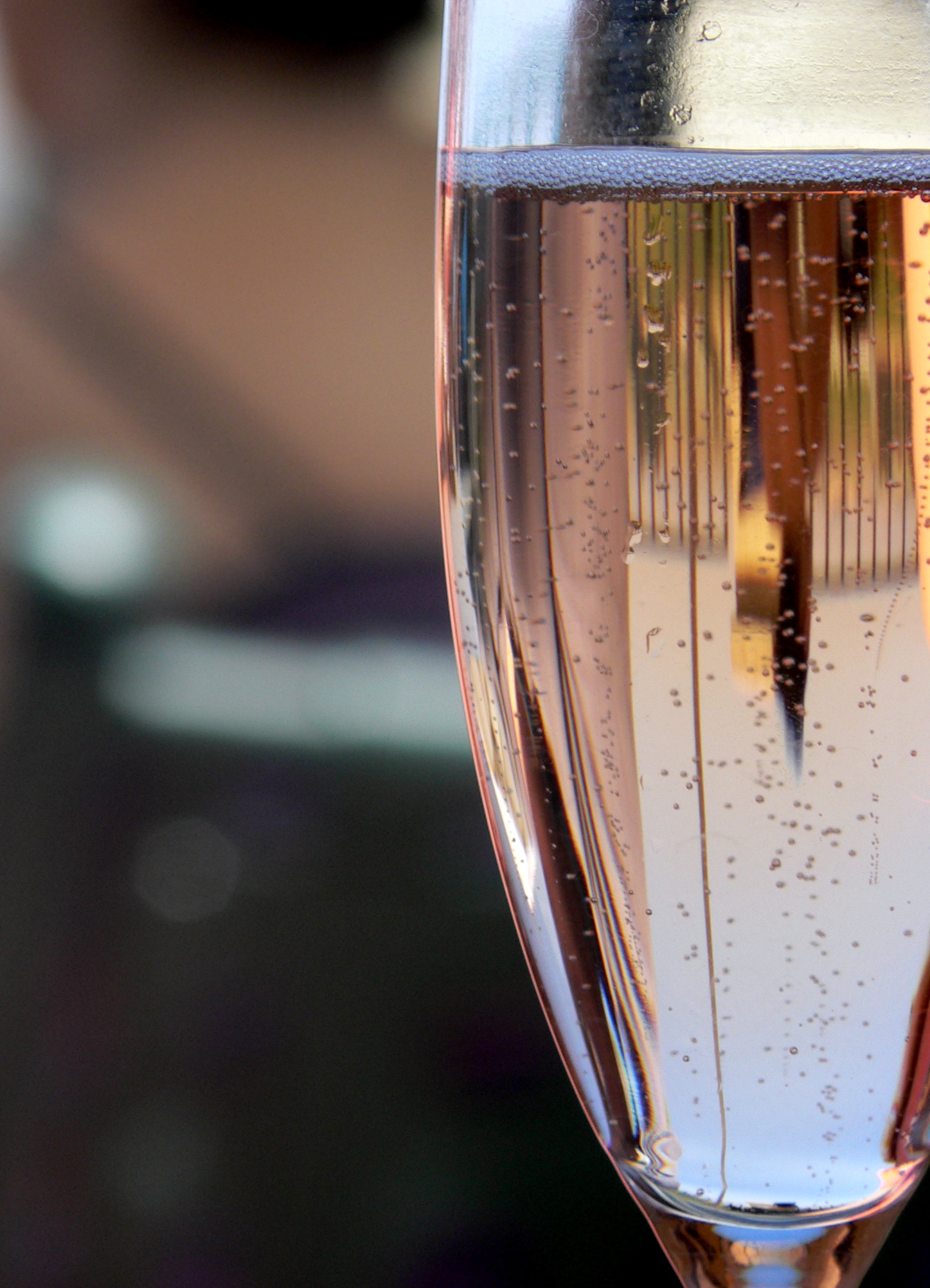 a champagne glass full of liquid next to another glass