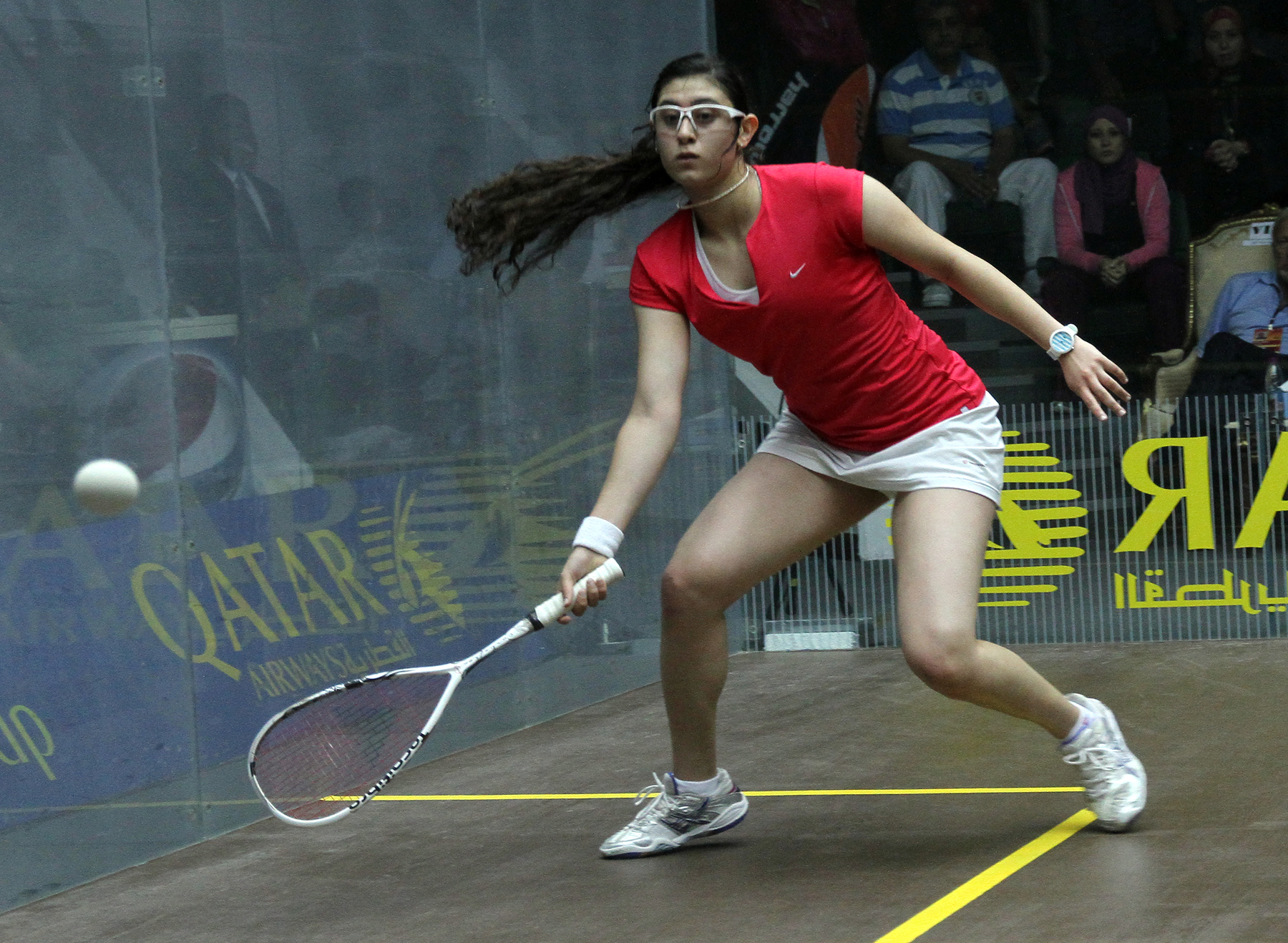 a woman taking a swing at a tennis ball