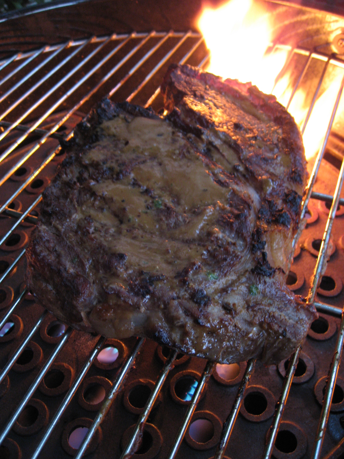 a grilled meat and vegetable is being cooked over fire