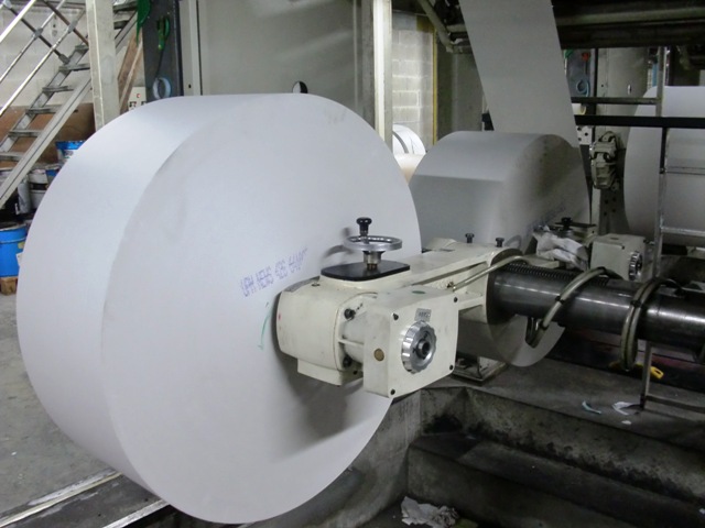 a metal object inside a factory making discs