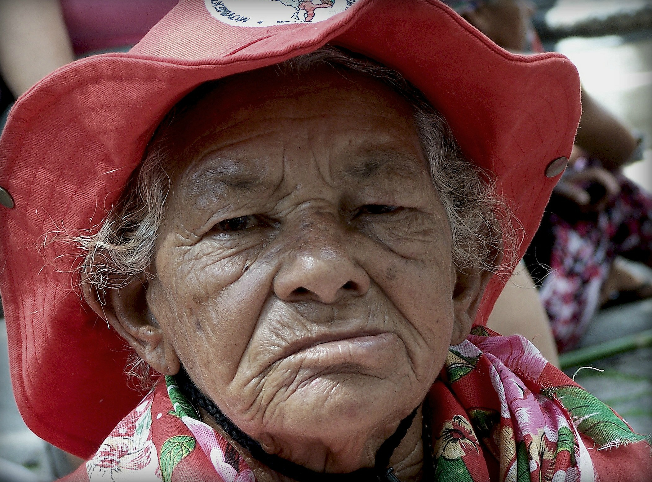 an older woman with a big red hat on