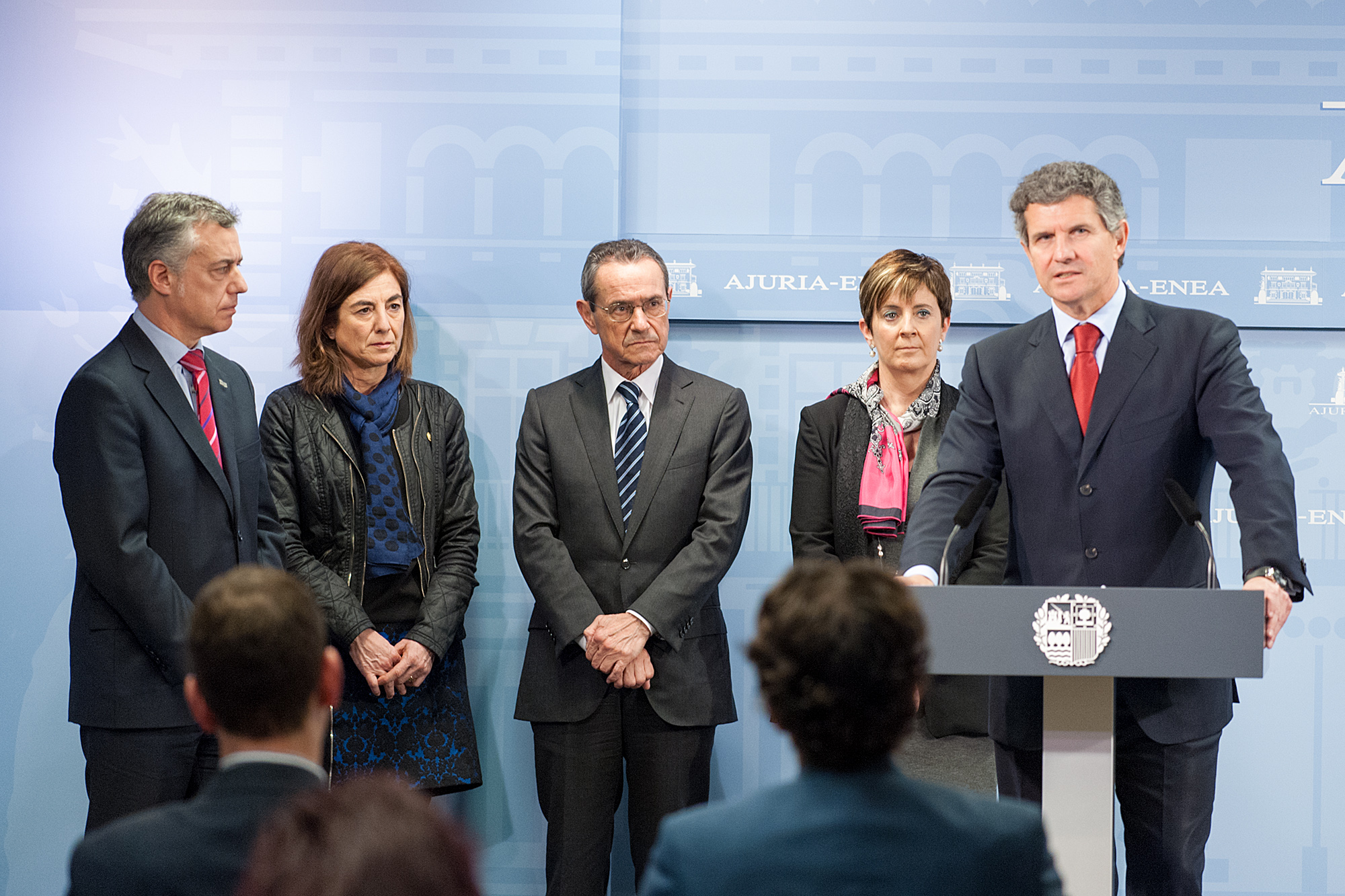 people standing in front of a press conference