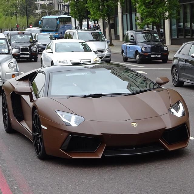 some very nice looking cars driving on the road