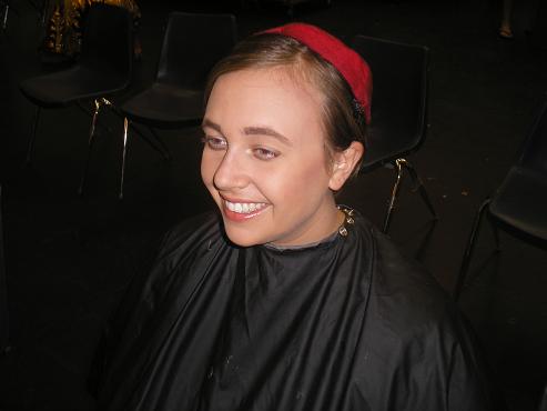 a woman sitting in a black chair smiling