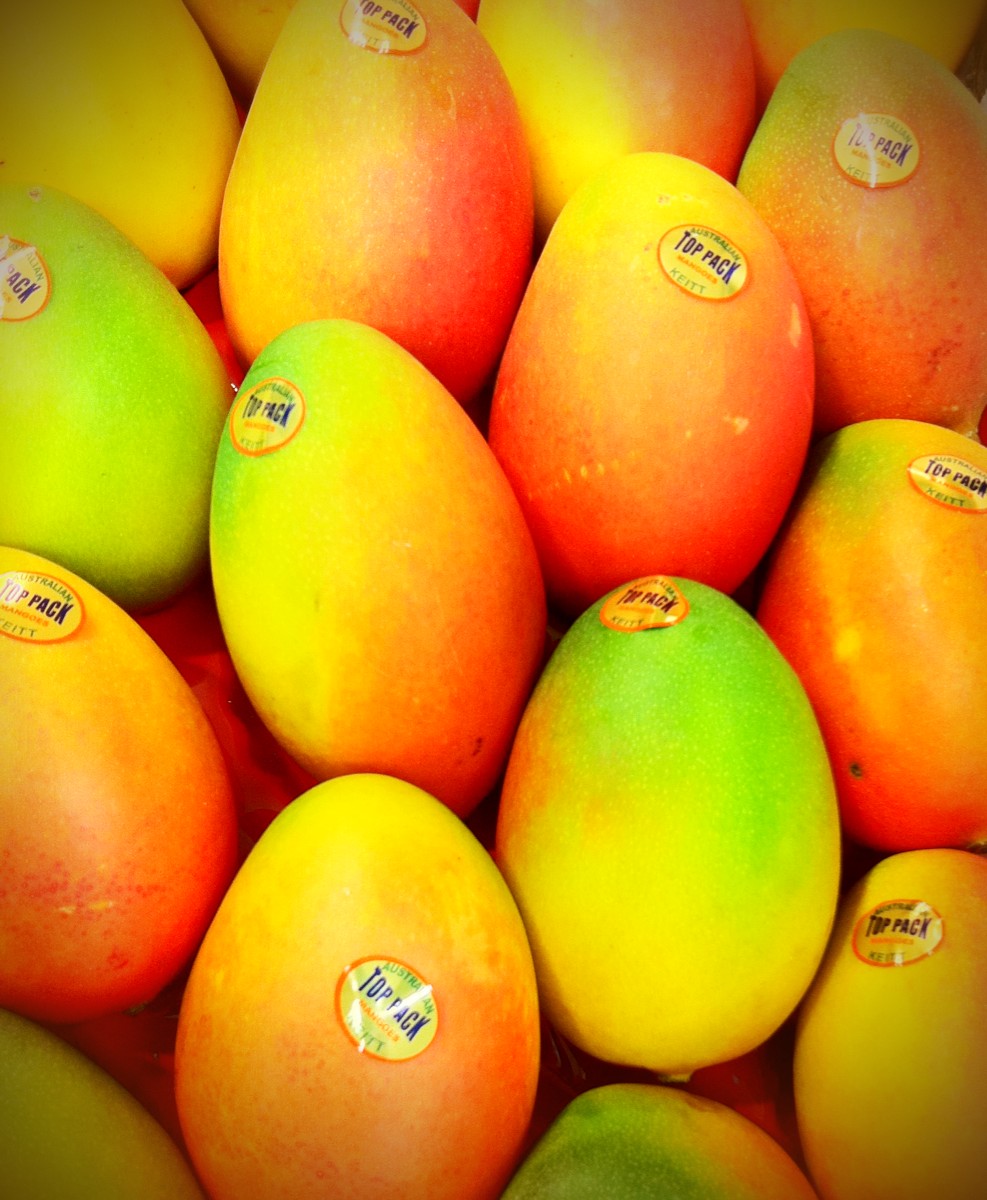 this is a bunch of mangoes in a big basket