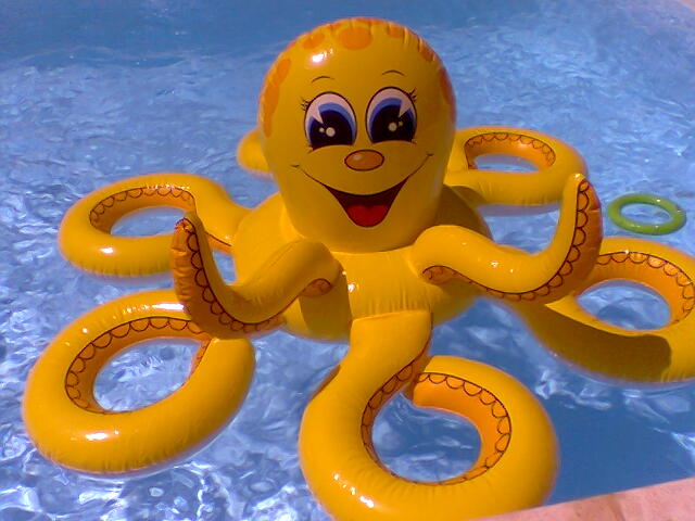 an inflatable octo floats in a pool with bubbles